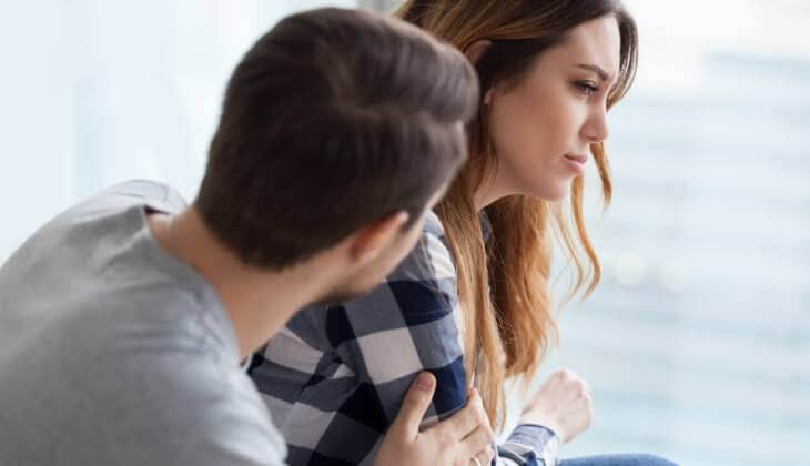 a man is comforting a sad woman