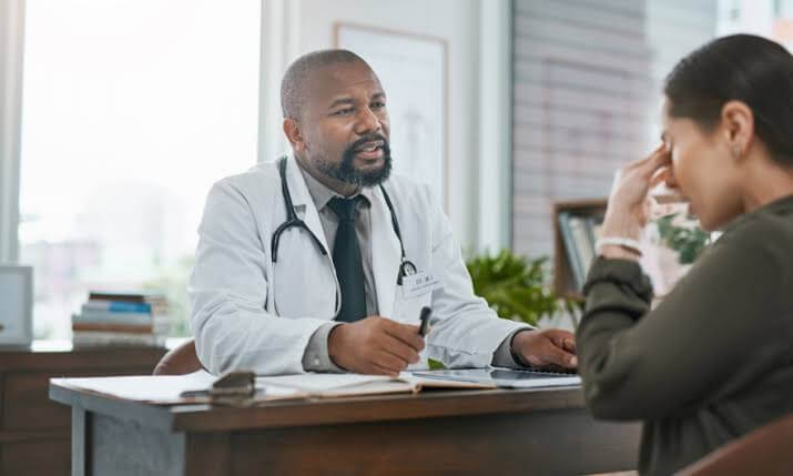 A doctor is talking to a distressed woman