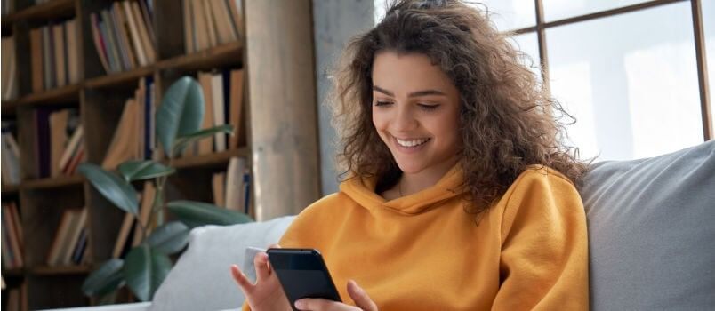 a woman is using her home with smle